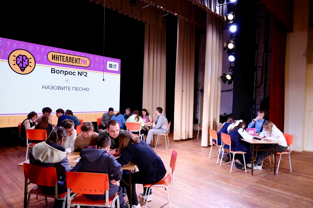 Участники игры сидят за столами